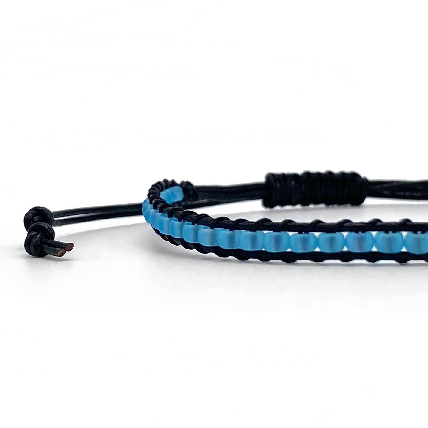 Handmade bracelet with adjustable length by Zosimi Beads, made with leather and glass beads combining black with aqua blue in a beautiful colour combination that is both masculine and diverse. Check it out:
____
menandunderwear.com/shop